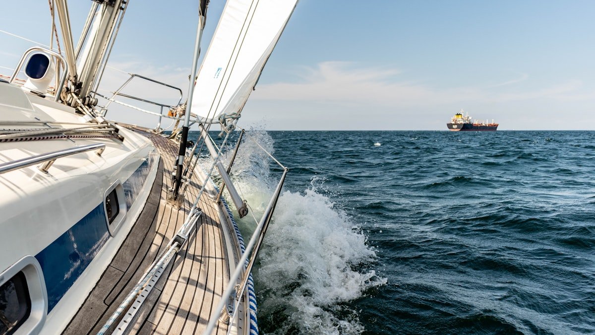 Surveyor inspecting a sailboat hull and deck join
