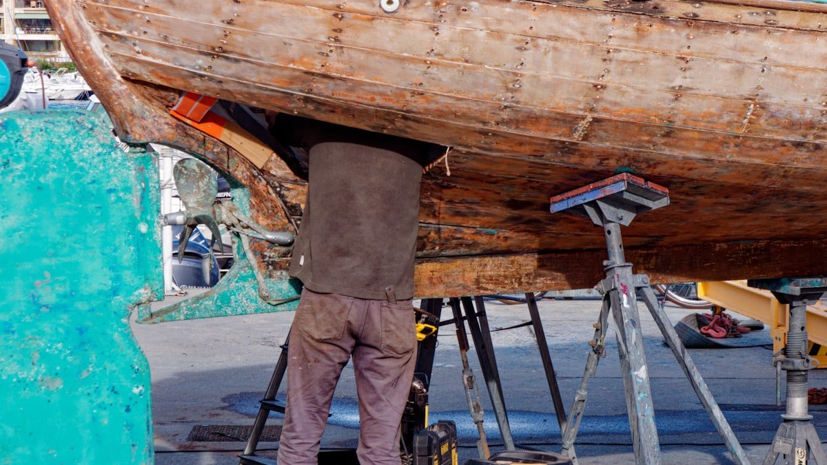 Sailboat hull being inspected in a boatyard