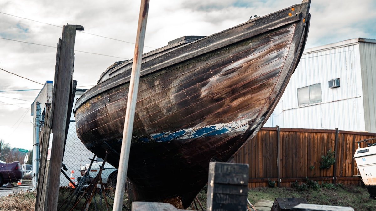 Sailboat hull being inspected in a boatyard