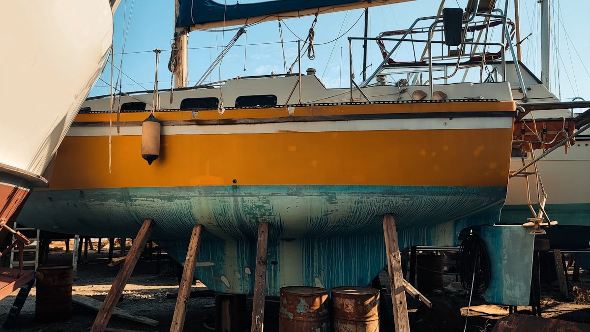 Catamaran hull being inspected in a boatyard