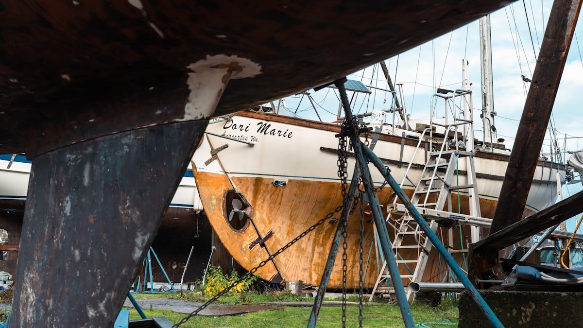 Catamaran hull being inspected in a boatyard
